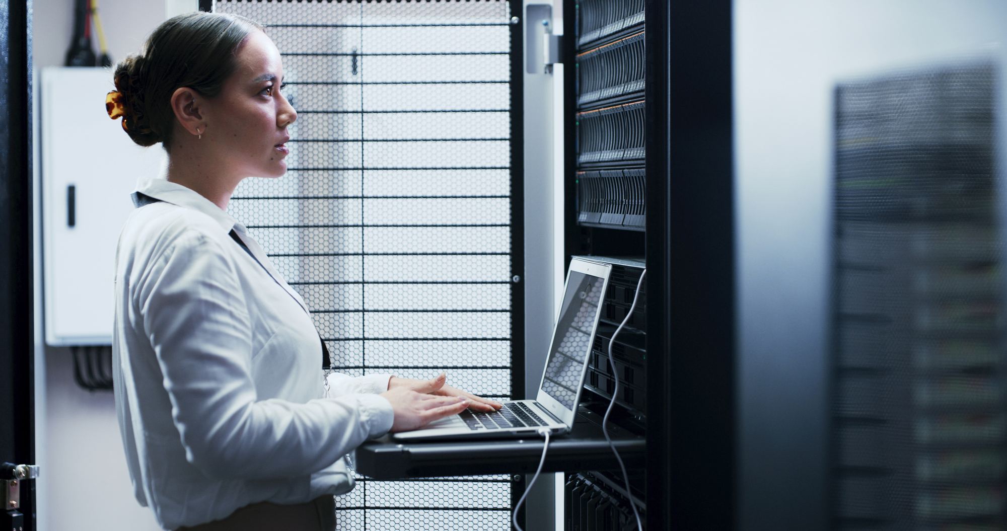 A technician working at an open server rack